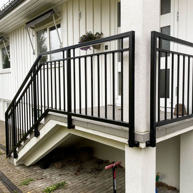 Lakkert spilerekkverk på trapp.