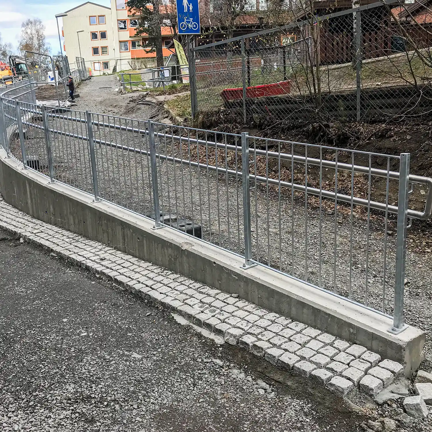 Rekkverk på mur med vertikale spiler.